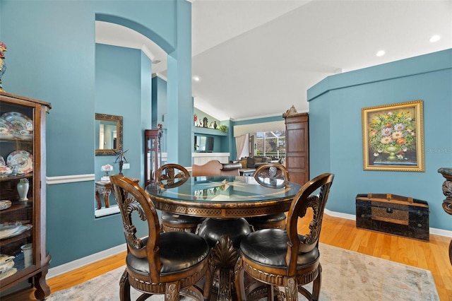 dining space featuring hardwood / wood-style floors and lofted ceiling