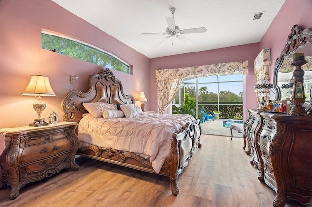 bedroom featuring access to outside, light hardwood / wood-style floors, and ceiling fan