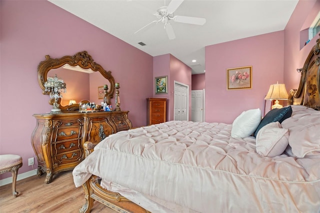 bedroom featuring ceiling fan, light hardwood / wood-style floors, and a closet