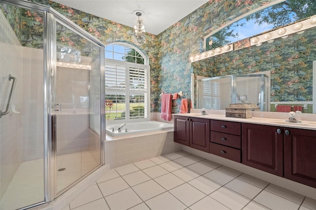 bathroom with vanity, tile patterned flooring, and plus walk in shower