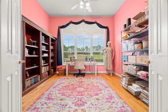 home office with ceiling fan and hardwood / wood-style flooring