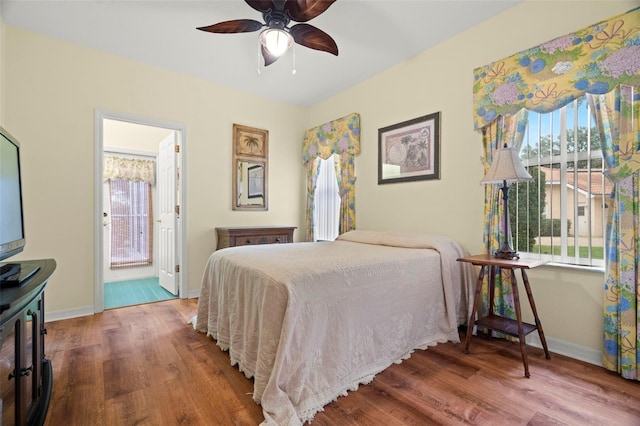 bedroom with ensuite bathroom, ceiling fan, and hardwood / wood-style flooring