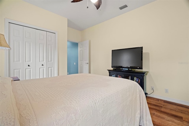 bedroom featuring ceiling fan, a closet, and wood-type flooring