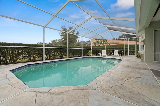 view of swimming pool with a lanai and a patio area