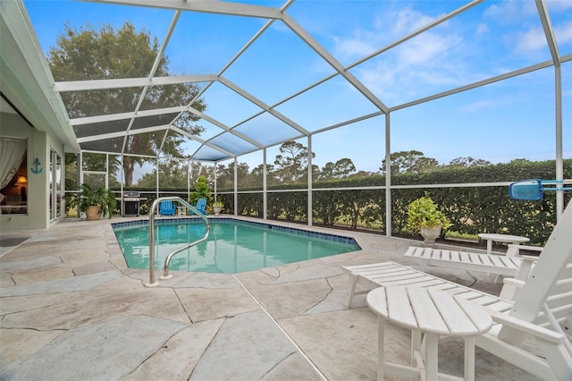 view of swimming pool with a lanai and a patio