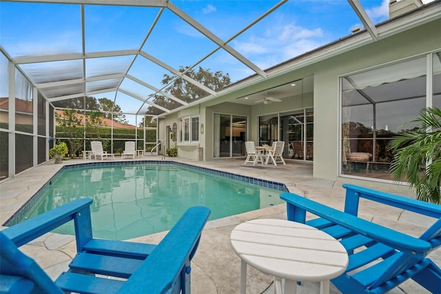 view of pool featuring a patio, ceiling fan, and a lanai