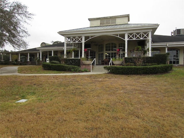 back of house featuring a yard and central AC unit