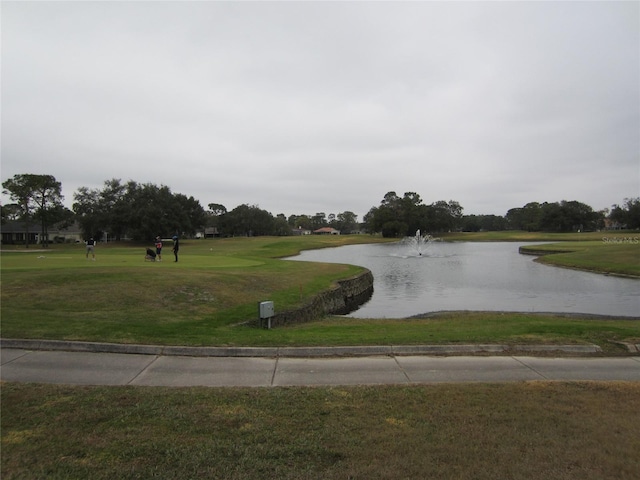 surrounding community with a yard and a water view