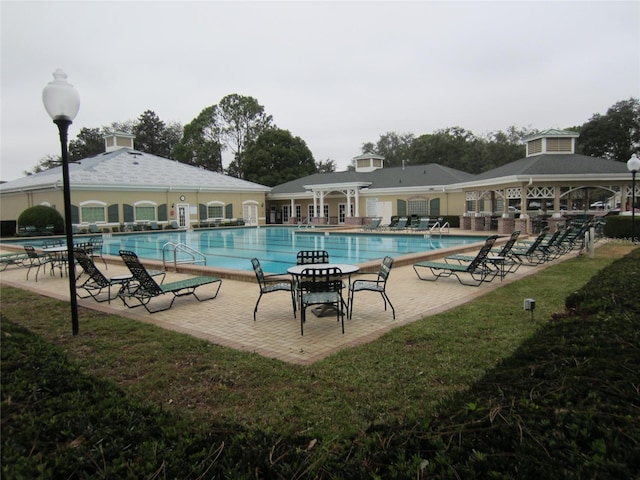 view of pool with a yard and a patio