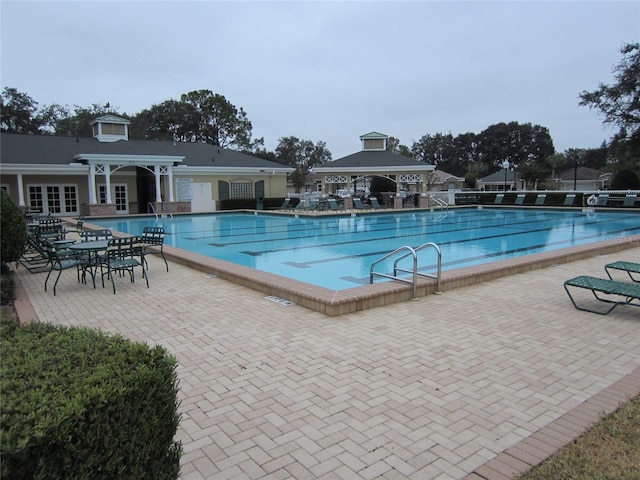 view of swimming pool featuring a patio area