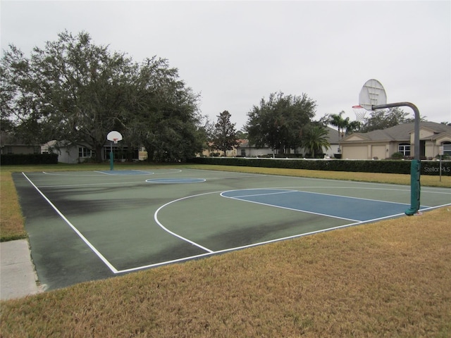 view of basketball court with a yard