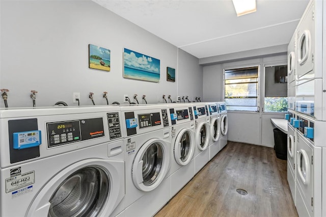 laundry room featuring washer and dryer, stacked washer / drying machine, and light wood-type flooring