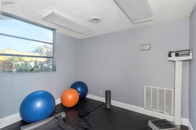 exercise area with a textured ceiling