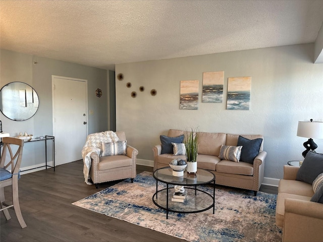 living room featuring dark hardwood / wood-style floors and a textured ceiling