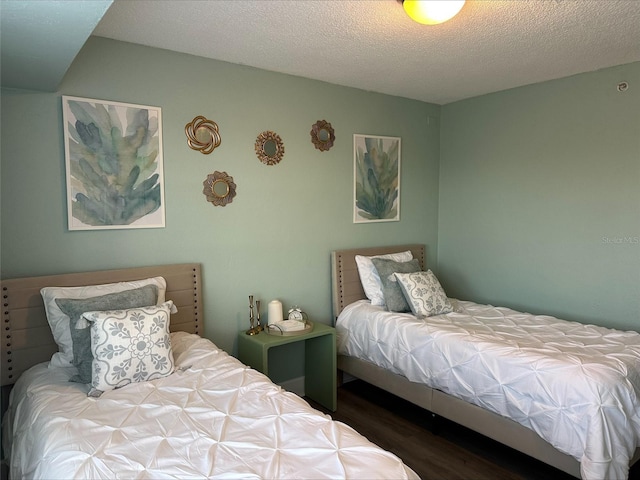 bedroom featuring wood-type flooring and a textured ceiling