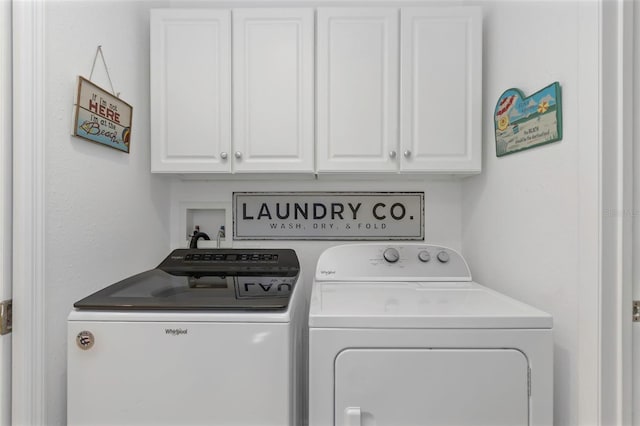 laundry area with cabinet space and separate washer and dryer