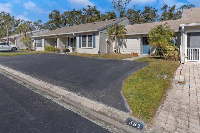 single story home featuring a front lawn