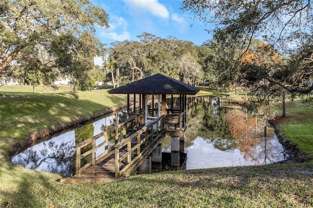 view of dock featuring a yard and a water view