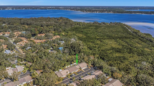birds eye view of property featuring a water view, a view of trees, and a residential view
