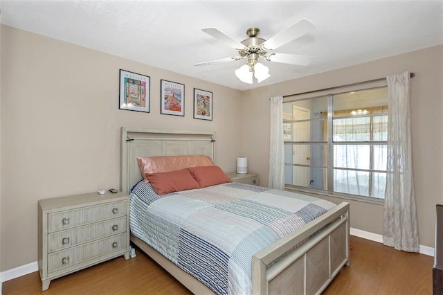 bedroom with wood finished floors, ceiling fan, and baseboards