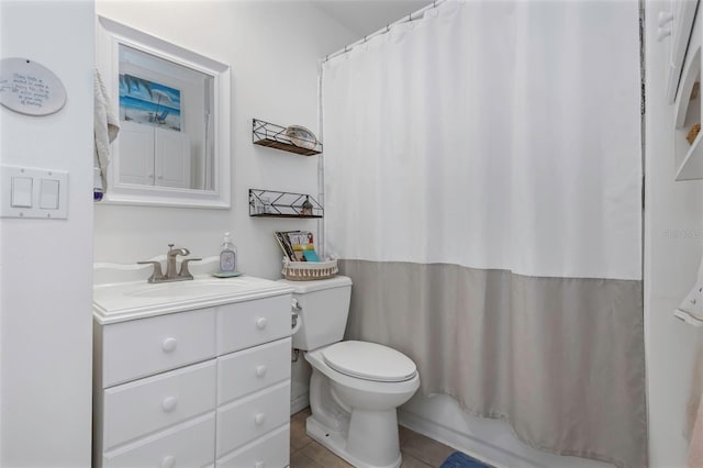 bathroom featuring tile patterned flooring, vanity, and toilet