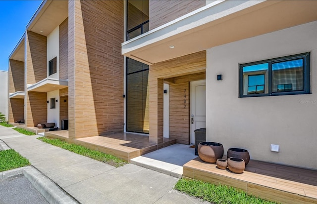 view of exterior entry featuring a balcony