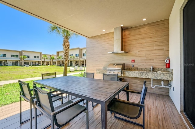 wooden terrace with a lawn and grilling area