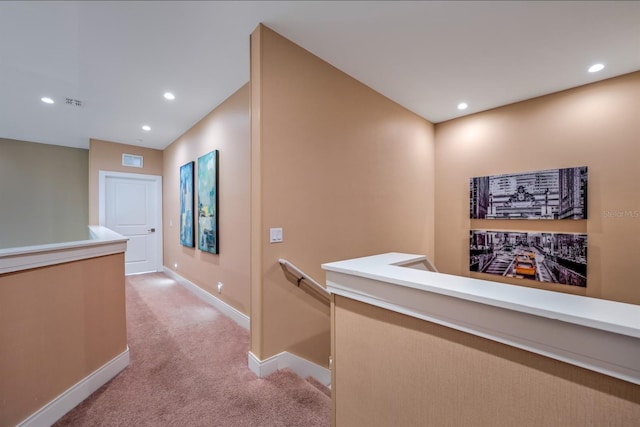 hallway featuring light colored carpet