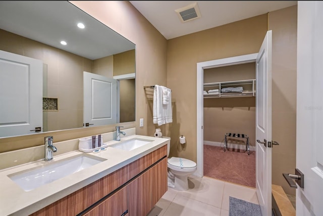 bathroom with tile patterned flooring, vanity, and toilet