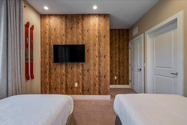 bedroom featuring carpet and wood walls