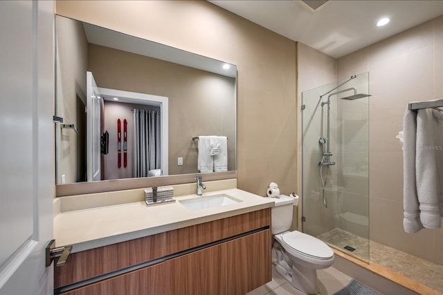 bathroom featuring tile patterned floors, vanity, toilet, and an enclosed shower