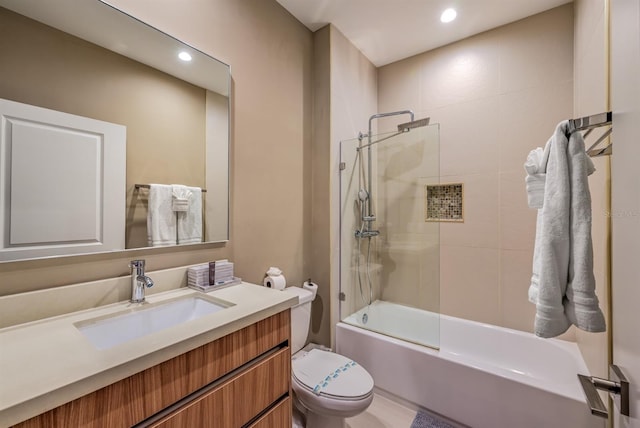 full bathroom featuring vanity, toilet, and bath / shower combo with glass door