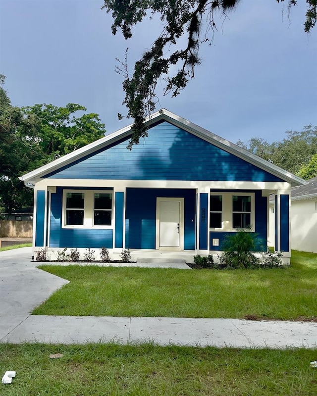 view of front of home with a front yard and a porch