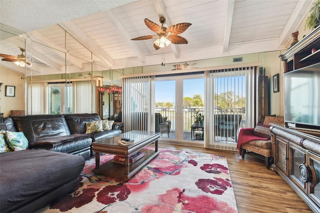 living room featuring wood ceiling, ceiling fan, lofted ceiling with beams, and light wood-type flooring