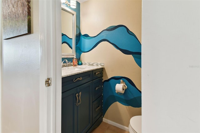 bathroom featuring tile patterned floors, vanity, and toilet