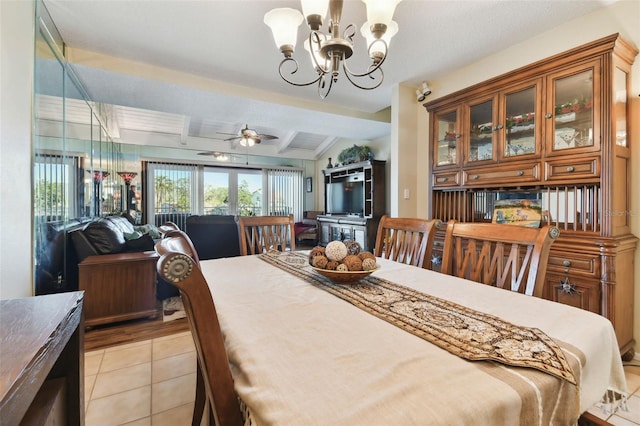 dining room featuring ceiling fan with notable chandelier, light tile patterned flooring, and lofted ceiling