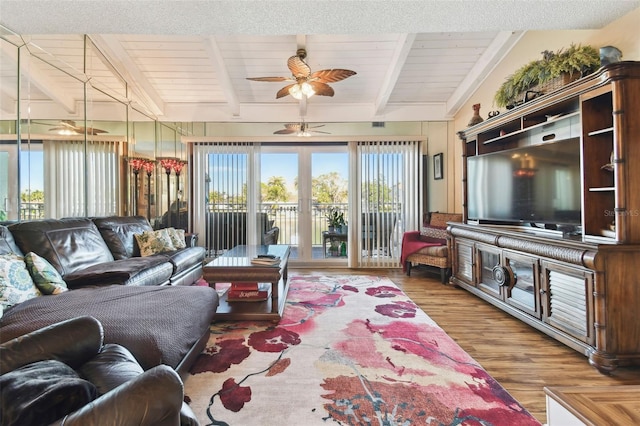 living room featuring wooden ceiling, french doors, hardwood / wood-style flooring, ceiling fan, and beam ceiling