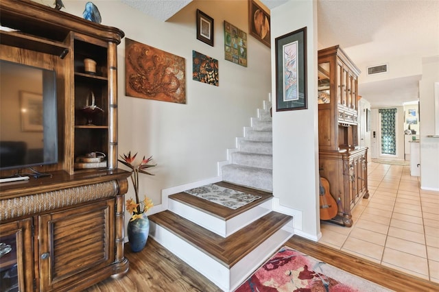 stairs with tile patterned floors