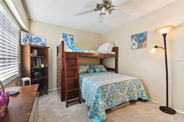 bedroom with ceiling fan and light carpet