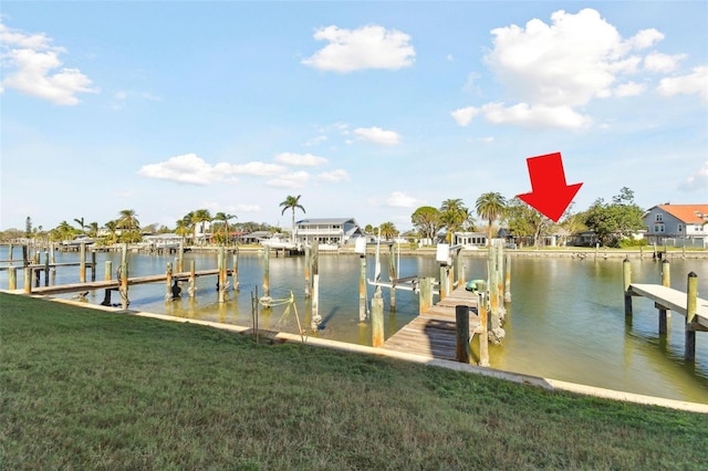 dock area featuring a yard and a water view