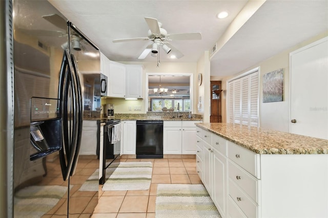 kitchen featuring sink, white cabinets, light tile patterned flooring, black appliances, and ceiling fan with notable chandelier