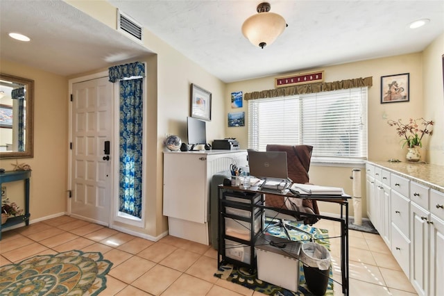 tiled home office with a textured ceiling