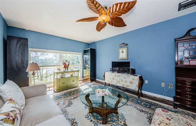 living room featuring hardwood / wood-style flooring and ceiling fan