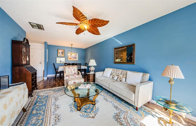 living room with ceiling fan, dark hardwood / wood-style flooring, and lofted ceiling