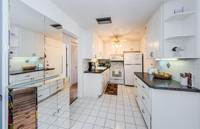 kitchen featuring decorative backsplash, white cabinets, and white appliances