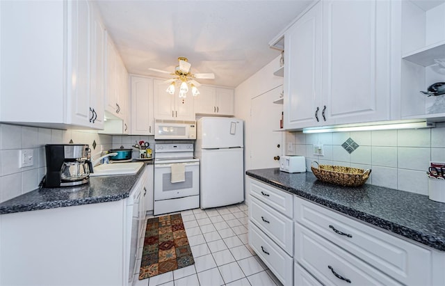 kitchen featuring white appliances, backsplash, sink, light tile patterned floors, and white cabinetry