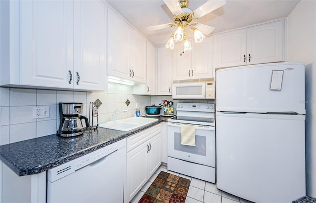 kitchen featuring white appliances, white cabinets, sink, tasteful backsplash, and light tile patterned flooring