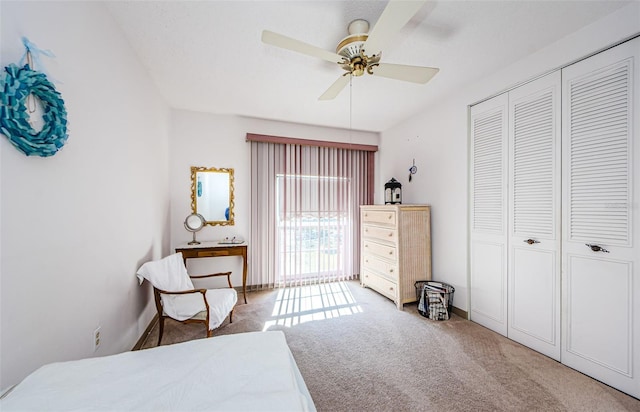 carpeted bedroom with ceiling fan and a closet