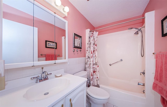 full bathroom with vanity, shower / bath combination with curtain, a textured ceiling, and toilet