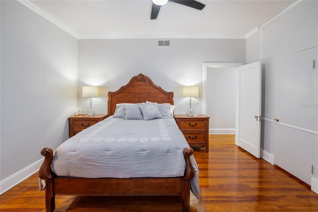 bedroom featuring ceiling fan, wood-type flooring, and ornamental molding